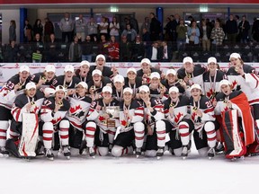The players of Canada pose with their gold medals and trophy after after The IIHF World Championship Woman's ice hockey gold medal match between USA and Canada in Herning, Denmark, Sunday, Sept. 4, 2022. Canada's women's hockey team will start it's quest for a third straight world title with a showdown against Switzerland when the 2023 championship begins this spring in Brampton, Ont.