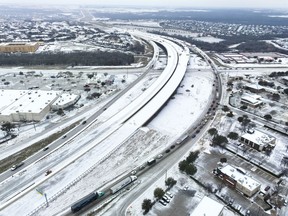An icy mix covers Highway 114 on Monday, Jan. 30, 2023, in Roanoke, Texas. Dallas and other parts of North Texas are under a winter storm warning through Wednesday.