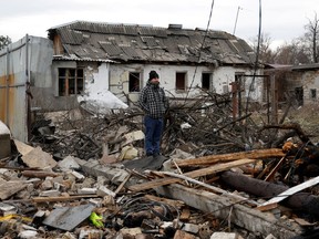 A man stands at a site of a residential house damaged during a Russian missile strike, amid Russia's attack on Ukraine, in Kyiv, Ukraine Dec. 29, 2022.