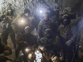 People in military uniform, claimed to be soldiers of Russian mercenary group Wagner and its head Yevgeny Prigozhin, pose for a picture believed to be in a salt mine in Soledar in the Donetsk region, Ukraine.