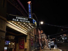 Pedestrians take photos of the marquee of the Egyptian Theatre before the 2023 Sundance Film Festival, Wednesday, Jan. 18, 2023, in Park City, Utah. The annual independent film festival runs from Jan. 19-29.