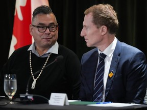 Former Tk'emlups te Secwepemc chief Shane Gottfriedson, left, and Minister of Crown-Indigenous Relations Marc Miller talk before a news conference, in Vancouver, on Saturday, January 21, 2023. The federal government says its come to a $2.8-billion agreement to settle a class-action lawsuit brought by two British Columbia first nations related to the collective harms caused by residential schools. The deal was signed with plaintiffs representing 325 members of the Gottfriedson Band that opted into the suit.