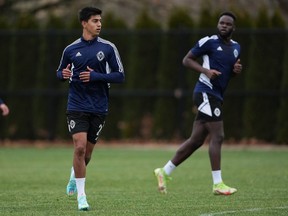 Vancouver Whitecaps defenders Mathias Laborda, front left, and Karifa Yao participate in a drill during the opening day of the MLS soccer team's training camp, in Vancouver, on Monday, January 9, 2023.