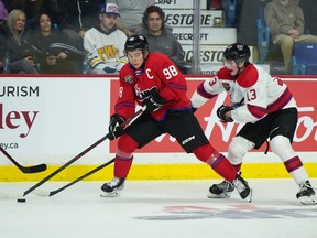 Team White's Kalan Lind (13) checks Team Red's Connor Bedard (98) during the second period of the CHL/NHL Top Prospects game, in Langley, B.C., on Wednesday, January 25, 2023.