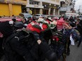 Palestinian Popular Front for the Liberation of Palestine militants carry the body of Omar Khmour, 14, during his funeral in Bethlehem's Dheisheh refugee camp in the occupied West Bank on January 16, 2023. - Israeli forces killed a Palestinian boy near Bethlehem in the occupied West Bank, the Palestinian health ministry said, where the army said they opened fire after people threw Molotov cocktails. Omar Khmour, 14, was shot in the head early on January 16, in the Dheisheh refugee camp in the southern West Bank and "succumbed to his wounds", the ministry said.