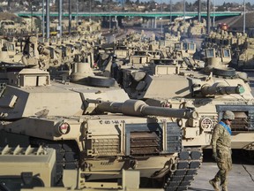 FILE - A soldier walks past a line of M1 Abrams tanks, Nov. 29, 2016, at Fort Carson in Colorado Springs, Colo. In what would be a reversal, the Biden administration is poised to approve sending M1 Abrams tanks to Ukraine, U.S. officials said Tuesday, as international reluctance toward sending tanks to the battlefront against the Russians begins to erode. The decision could be announced as soon as Wednesday though it could take months or years for the tanks to be delivered.