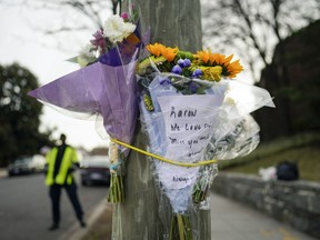 FILE - Flowers are secured to a pole as a memorial to Karon Blake, 13, on the corner of Quincy Street NE and Michigan Avenue NE in the Brookland neighborhood of Washington, Jan. 10, 2023. The note reads, "Karon we will love and miss you dearly." Jason Lewis, a longtime Parks and Recreation Department employee, turned himself in Tuesday morning to face charges of second-degree murder while armed. Lewis shot middle schooler Karon Blake on Jan. 7, around 4 a.m.