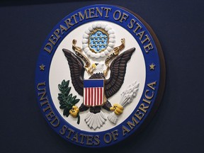 FILE - The State Department seal is seen on the briefing room lectern at the State Department in Washington, Jan. 31, 2022. Everyday Americans will be able to help refugees adjust to life in the U.S. in a program being launched by the State Department. The goal is to give private citizens a role in resettling the thousands of refugees who come to America every year. The State Department is calling the new program the Welcome Corps.