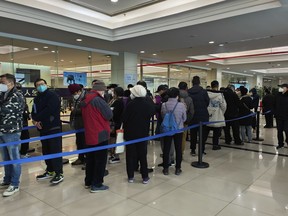 Family members of the deceased line up for the cremation procedures at a funeral home in Shanghai, China on Jan. 4, 2023. China on Saturday, Jan. 14, reported nearly 60,000 deaths in people who had COVID-19 since early December following complaints the government was failing to release data about the status of the pandemic. (Chinatopix Via AP)