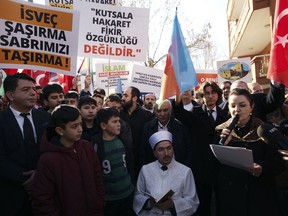 An Imam recites from the Quran, Islam's holy book, during a demonstration outside the Swedish embassy in Ankara, Turkey, Tuesday, Jan. 24, 2023. Outrage over a Quran-burning by a Danish-Swedish anti-Islam politician in Stockholm on Saturday caused protests in Turkey, reflecting tensions between the two countries.