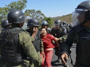 FILE - A woman is detained by Mexican army military police in a neighborhood in the city of Chilpancingo, Mexico, Friday, Feb. 6, 2015. Mexico´s Supreme Court ruled Tuesday, Jan 24, 2023, that soldiers can make an arrest without telling police, as long as they eventually register the arrest in a computer system that civilian agencies use.