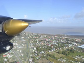 File - Georgetown, Guyana is seen over the propeller of a plane headed to Kaieteur Falls, Guyana, March 7, 2016. The former leader of Guyana's Environmental Protection Agency, Vincent Adams, is criticizing the government's plan to use satellites to monitor oil spills in the South American nation's waters, saying to the Associated Press on Jan. 24, 2023 that the only proper way of minimizing oil spills is to put spill-prevention experts onboard drilling ships and platforms.