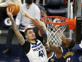 Then-Minnesota Timberwolves forward Juancho Hernangomez (41) shoots against then-Denver Nuggets guard Will Barton in the second quarter during an NBA basketball game, in Minneapolis, Sunday, Jan. 3, 2021. The Toronto Raptors signed guard Barton and, in turn, forward Juancho Hernangomez on Tuesday.