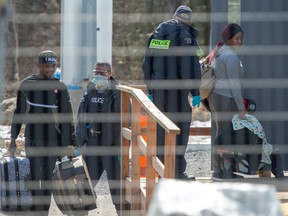 Asylum seekers cross the border from New York into Canada at Roxham Road Wednesday, March 18,, 2020 in Hemmingford, Que. THE CANADIAN PRESS/Ryan Remiorz