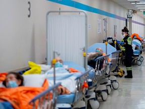 Paramedics transfer patients to the emergency room but have no choice but to leave them in the hallway due to capacity issues at a hospital in Toronto in 2022.
