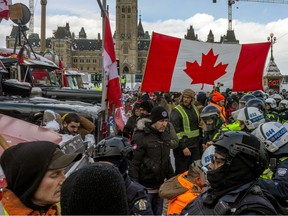 OTTAWA, ONTARIO - FEBRUARY 19: Police face off with demonstrators participating in a protest organized by truck drivers opposing vaccine mandates on Wellington St. on February 19, 2022 in Ottawa, Ontario. Canada Prime Minister Justin Trudeau has invoked the Emergencies Act in an attempt to try to put an end to the demonstration that has nearly paralyzed a portion of downtown Ottawa for three weeks.