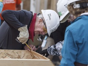 Former U.S. president Jimmy Carter measures a set of stairs as he helps build homes for Habitat for Humanity in Edmonton on Tuesday July 11, 2017. Many who worked alongside him in Alberta have shared memories and well-wishes since it was announced that Carter is to spend his remaining time at home with his family, receiving hospice care.