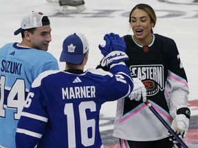Montreal Canadiens' Nick Suzuki (14) and Toronto Maple Leafs' Mitchell Marner (16) congratulate Canadian hockey player Sarah Nurse after she scored a goal during the NHL All Star Skills Showcase, Friday, Feb. 3, 2023, in Sunrise, Fla.&nbsp;The 2024 NHL all-star game will be played in Toronto.
