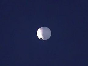A high-altitude balloon floats over Billings, Mont., on Wednesday, Feb. 1, 2023. The Department of National Defence says Canada is working with the United States to protect sensitive information from foreign intelligence threats after a high-altitude surveillance balloon was detected.