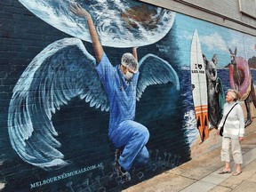 A mural in Melbourne, Australia, depicts a health worker with wings in a file photo from May 12, 2020.