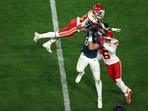 Dallas Goedert #88 of the Philadelphia Eagles reaches for a catch against L’Jarius Sneed #38 of the Kansas City Chiefs and Bryan Cook #6 of the Kansas City Chiefs during the third quarter in Super Bowl LVII at State Farm Stadium on February 12, 2023 in Glendale, Arizona.