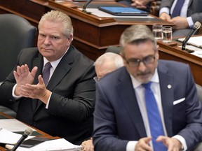 Premier Doug Ford applauds Long-Term Care Minister Paul Calandra in the Ontario legislature — a place where no one ever need apologize.