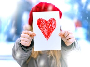 A girl holds a Valentine.