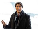 Prime Minister Justin Trudeau speaks on the edge of the tarmac at Erik Nielsen International Airport in Whitehorse, Yukon, February 13, 2023.