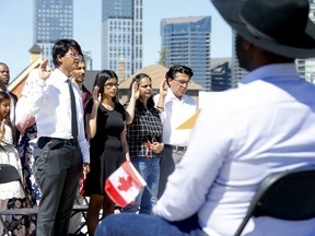 A 2022 citizenship ceremony at the Calgary Stampede. Far fewer immigrants are pursuing citizenship than just 20 years ago.