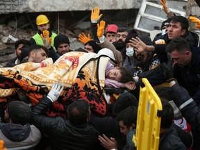 Rescuers carry out a girl from a collapsed building following an earthquake in Diyarbakir, Turkey February 6, 2023. REUTERS/Sertac Kayar