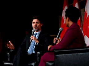 Prime Minister Justin Trudeau, left, participates in a Black History Month reception at the National Arts Centre in Ottawa in 2020.