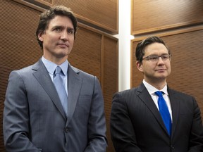 Prime Minister Justin Trudeau stands with Conservative Leader Pierre Poilievre as he waits to speak at a Tamil heritage month reception in Ottawa, January 30, 2023.