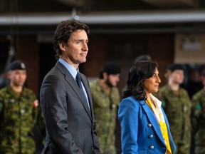 Prime Minister Justin Trudeau and Defence Minister Anita Anand prepare to make an announcement on the one-year anniversary of Russia's invasion of Ukraine, at Fort York Armoury in Toronto, February 24, 2023.
