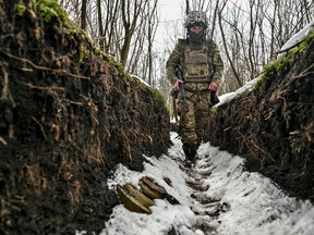 A Ukrainian soldier walks inside a trench near the frontline in Zaporizhzhia region, Ukraine.