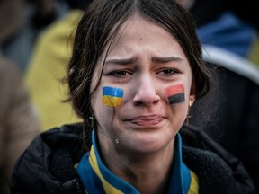 A young woman reacts during a rally marking the first anniversary of the Russian invasion of Ukraine in front of the Russian embassy in Copenhagen, on February 24, 2023. (Photo by  / Ritzau Scanpix / AFP) / Denmark OUT