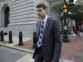 FILE - Nathan Carman departs federal court, Wednesday, Aug. 21, 2019, in Providence, R.I. A federal judge on Tuesday, Feb. 7, 2023 set an October 2023 trial date for Carman, who is charged with killing his mother at sea during a 2016 fishing trip off the coast of New England in what prosecutors say was a scheme to inherit millions of dollars.