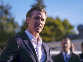 California Gov. Gavin Newsom speaks Tuesday, Jan. 24, 2023, at the I.D.E.S. Portuguese Hall in Half Moon Bay, Calif., with victims' families, local leaders and community members that were impacted by the devastating shootings the day before.