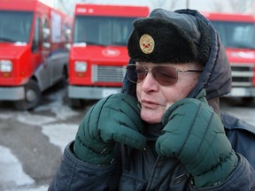 A Canada Post commissionaire keeps his eye on unlawful motorists in Canada Post's parking lot.