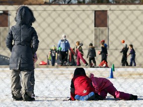 Children play in a Winnipeg schoolyard in December 2020.