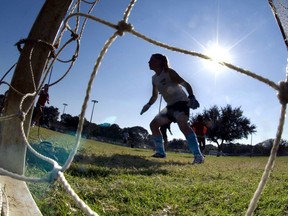 FILE - The goalkeeper guards the net as girls take part in the first day of tryouts for the Fort Walton Beach High School girls' soccer team in Fort Walton Beach, Fla., on Oct. 10, 2012. Facing blowback, the leader of Florida's high school sports association is backing away from using a permission form that requires female athletes to disclose their menstrual history. The association's board is meeting Thursday, Feb. 9, 2023, to vote on whether to adopt a new recommendation that most personal information revealed on a medical history form be left at the doctor's office and not stored at school.