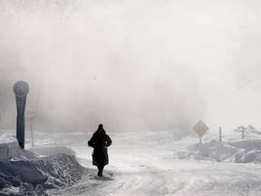 A person walks through a park during frigid temperatures in Montreal, Saturday, Feb. 4, 2023.