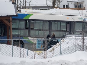 A city bus is shown next to a daycare centre in Laval, Que, Wednesday, February 8, 2023, where the driver crashed it into the building leaving two children dead.