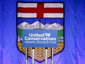 A United Conservative Party of Alberta sign is shown in front of the Alberta flag prior to the party's leadership announcement in Calgary on Thursday, Oct. 6, 2022. A member of Alberta's UCP government caucus who was recently named a parliamentary secretary for civil liberties has announced she won't seek re-election.THE CANADIAN PRESS/Jeff McIntosh