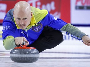 Team Alberta skip Kevin Koe makes a shot during finals action against Team Wild Card One at the Tim Hortons Brier in Lethbridge, Alta., Sunday, March 13, 2022.