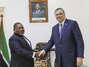 In this photo supplied by the Mozambican Presidency, Mozambican President Filipe Nyusi, left, shakes hands with TotalEnergies CEO Patrick Pouyanne at a meeting in Maputo, Mozambique, Friday, Feb. 3 2023. Extremist rebels in the county's northern Cabo Delgado province have killed a worker for an international charity shortly after a former vice president of the organization was asked to produce a report into the humanitarian situation in the conflict-hit region. In March 2021 Mozambique's Islamic extremist insurgency forced the France-based firm TotalEnergies to put on hold its $20 billion liquified natural gas project in the north of the province. (Photo Mozambican Presidency via AP).