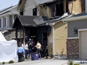 FILE - Investigators stand outside a house where five immigrants from Senegal were found dead after a fire in suburban Denver on Aug. 5, 2020. One of three teens accused of starting the fire is set to be sentenced Wednesday, Feb. 1, 2023. Court records show Dillon Siebert, the youngest of the three and now 17, pleaded guilty to second-degree murder in December 2022. He was not previously identified because he was charged as a juvenile.