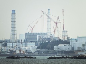 FILE - The Fukushima Daiichi nuclear power plant sits in coastal towns of both Okuma and Futaba, as seen from the Ukedo fishing port in Namie town, northeastern Japan, Wednesday, March 2, 2022. Japanese nuclear regulators on Monday, Feb. 13, 2023 approved contentious safety evaluation changes and draft legislation to allow aging reactors to operate longer, in a rare split decision in which one of the five commissioners dissented.