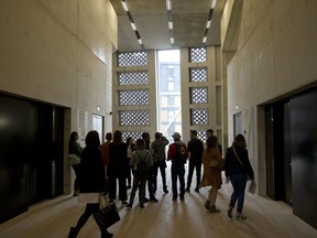 FILE - People stand in an area by the lifts in the new Switch House building extension to the Tate Modern gallery in London, Tuesday, June 14, 2016. Britain's Supreme Court ruled Wednesday, Feb. 1, 2023, that a viewing platform at London's Tate Modern art gallery made residents of luxury apartments next door feel like animals in a zoo, and impeded "the ordinary use and enjoyment" of their homes.