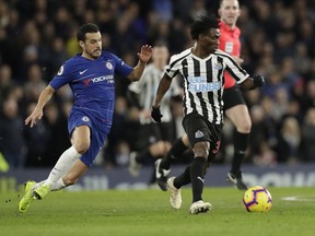 FILE - Chelsea's Pedro, left, and Newcastle United's Christian Atsu vie for the ball during the English Premier League soccer match between Chelsea and Newcastle United at Stamford Bridge stadium in London, on, Jan. 12, 2019. Former Chelsea and Newcastle forward Christian Atsu is missing and believed to be trapped under rubble following the powerful earthquake that struck Turkey on Monday and left more than 2,500 people dead. The Ghana international plays for Turkish club Hatayspor and a club spokesman says he is thought to be in a building that was destroyed.