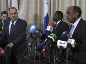 Russian Foreign Minister Sergei Lavrov, left, and Sudanese acting foreign minister Ali al-Sadiq give a joint press conference at the airport in Khartoum, Sudan, Thursday, Feb. 9, 2023.